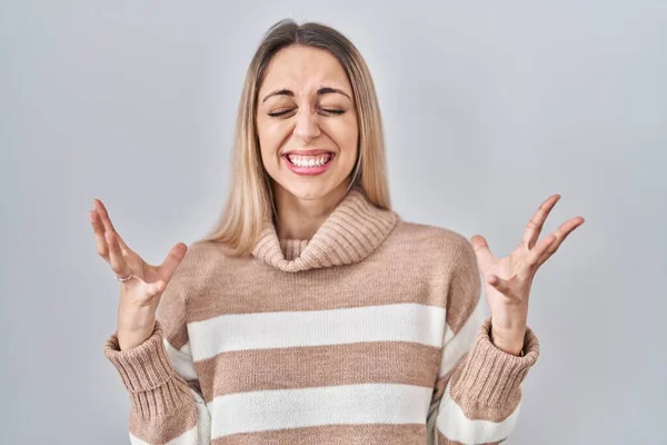 Young Blonde Woman Wearing Turtleneck Sweater Isolated Background Celebrating Mad — Stock Photo, Image