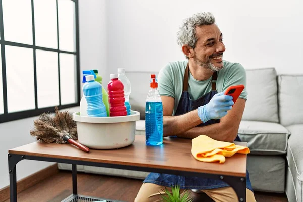 Middle Age Grey Haired Man Using Smartphone Cleaning Table Home — Photo