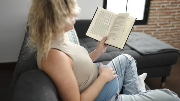 Young Pregnant Woman Reading Book Touching Belly Home — Stock Photo, Image