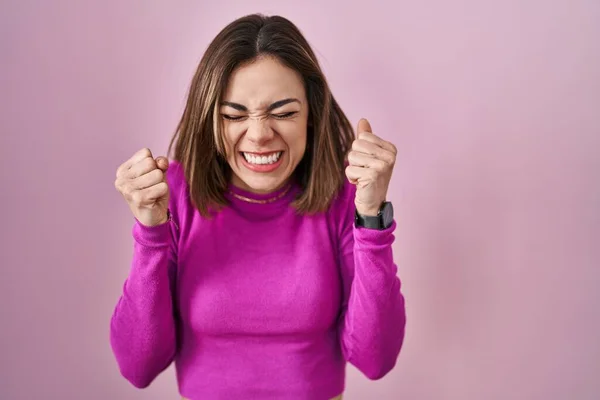 Hispanic Woman Standing Pink Background Excited Success Arms Raised Eyes — Foto Stock