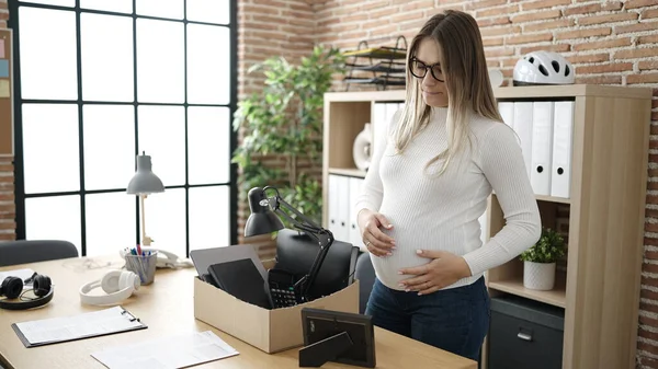 年轻的孕妇被解雇了 她在办公室里收拾东西 从办公室里摸到肚子 — 图库照片