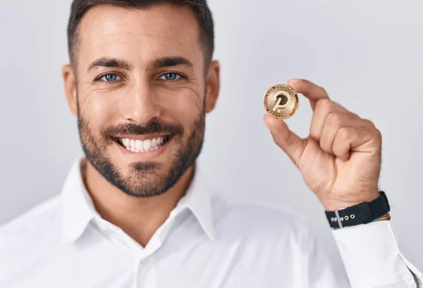 Handsome Hispanic Man Holding Polkadot Cryptocurrency Coin Looking Positive Happy — Stock Photo, Image