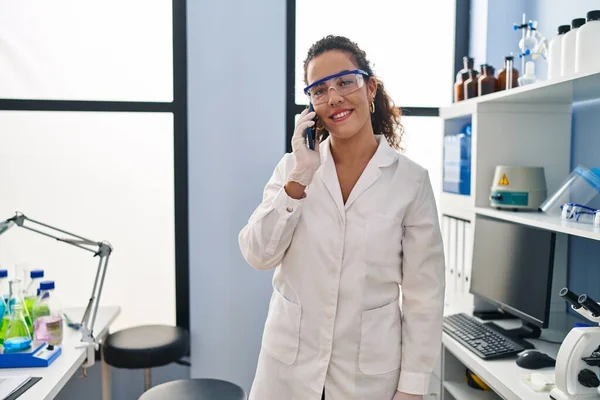 Young Beautiful Hispanic Woman Scientist Talking Smartphone Laboratory — Stock Photo, Image