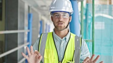 Kafkasyalı genç mimar inşaat alanında konuşuyor.