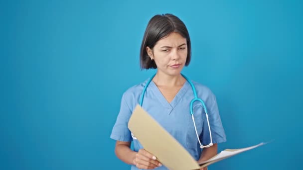 Young Beautiful Hispanic Woman Doctor Reading Document Saying Head Isolated — Stock Video