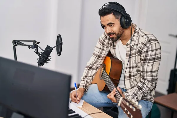 Young Hispanic Man Artist Composing Song Playing Guitar Music Studio — Fotografia de Stock