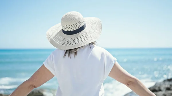 中年惊慌失措的女游客张开双臂站在海滩上 — 图库照片