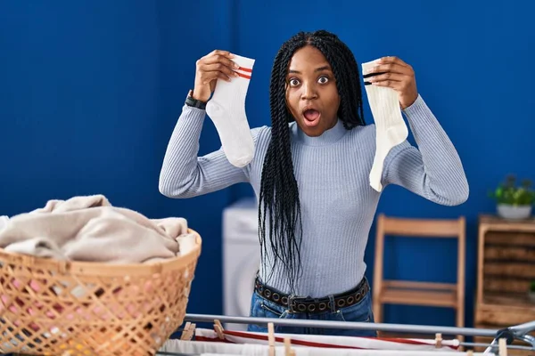African American Woman Holding Socks Afraid Shocked Surprise Amazed Expression — Stock Photo, Image