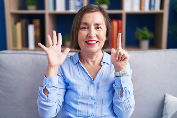 Middle Age Hispanic Woman Sitting Sofa Home Showing Pointing Fingers — Stock Photo, Image