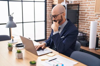 Young hispanic man business worker using laptop working at office