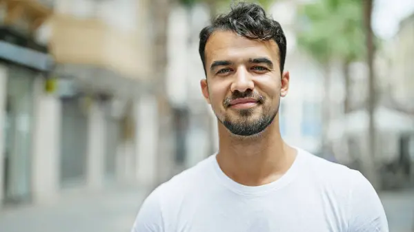 stock image Young hispanic man smiling confident standing at street