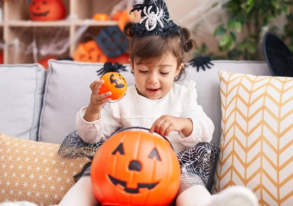 Adorable Hispanic Girl Wearing Halloween Costume Holding Pumpkin Basket Home — Stock fotografie