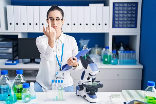 Young Brunette Woman Working Scientist Laboratory Showing Middle Finger Impolite — Photo