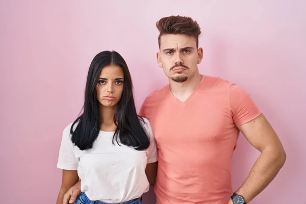 Young Hispanic Couple Standing Pink Background Depressed Worry Distress Crying — Stock Photo, Image