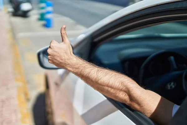 Young Caucasian Man Driving Car Doing Gesture Thumb Street — Stok fotoğraf