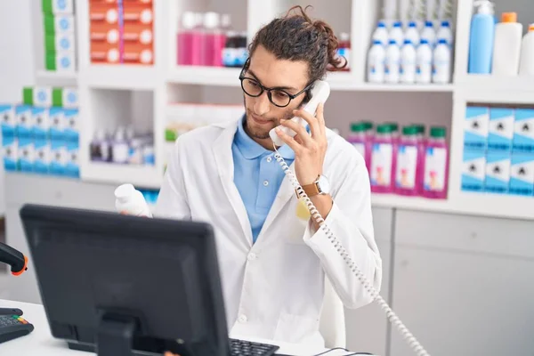 Young Hispanic Man Pharmacist Talking Telephone Holding Pills Bottle Pharmacy — 스톡 사진