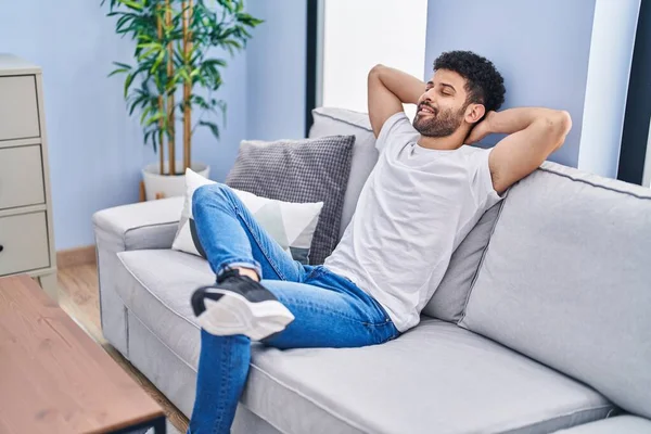 Young Arab Man Relaxed Hands Head Sitting Sofa Home — Stockfoto