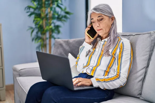 Middle Age Grey Haired Woman Using Laptop Talking Smartphone Home — ストック写真
