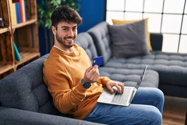 Young Hispanic Man Using Laptop Credit Card Sitting Sofa Home — Fotografia de Stock
