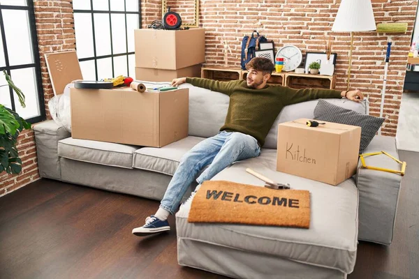 Young Arab Man Smiling Confident Relaxed Sofa New Home — Fotografia de Stock