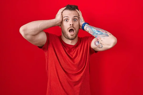 Young Hispanic Man Standing Red Background Crazy Scared Hands Head — Zdjęcie stockowe