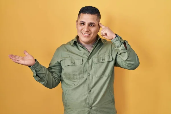 Hispanic Young Man Standing Yellow Background Confused Annoyed Open Palm — Stock Photo, Image