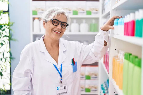 Middle Age Grey Haired Woman Pharmacist Holding Deodorant Bottle Pharmacy — Stock Photo, Image