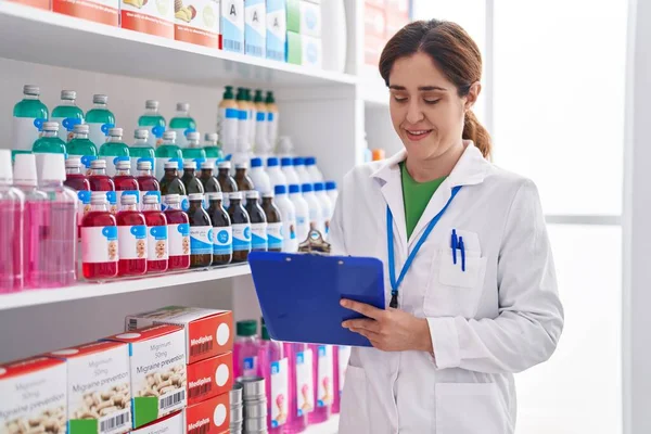 Young Woman Pharmacist Smiling Confident Writing Document Pharmacy — Foto de Stock