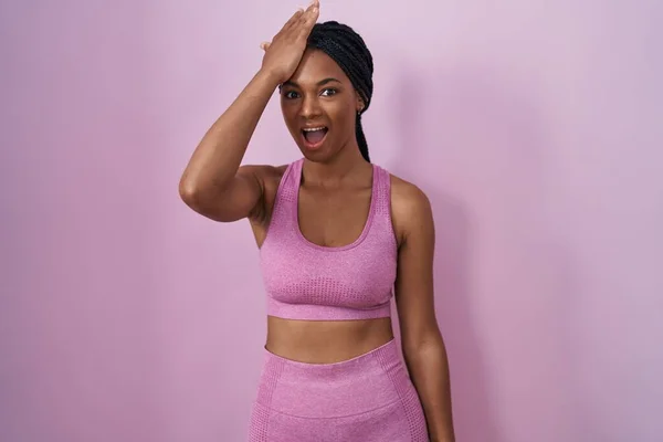 African American Woman Braids Wearing Sportswear Pink Background Surprised Hand — Stock Photo, Image