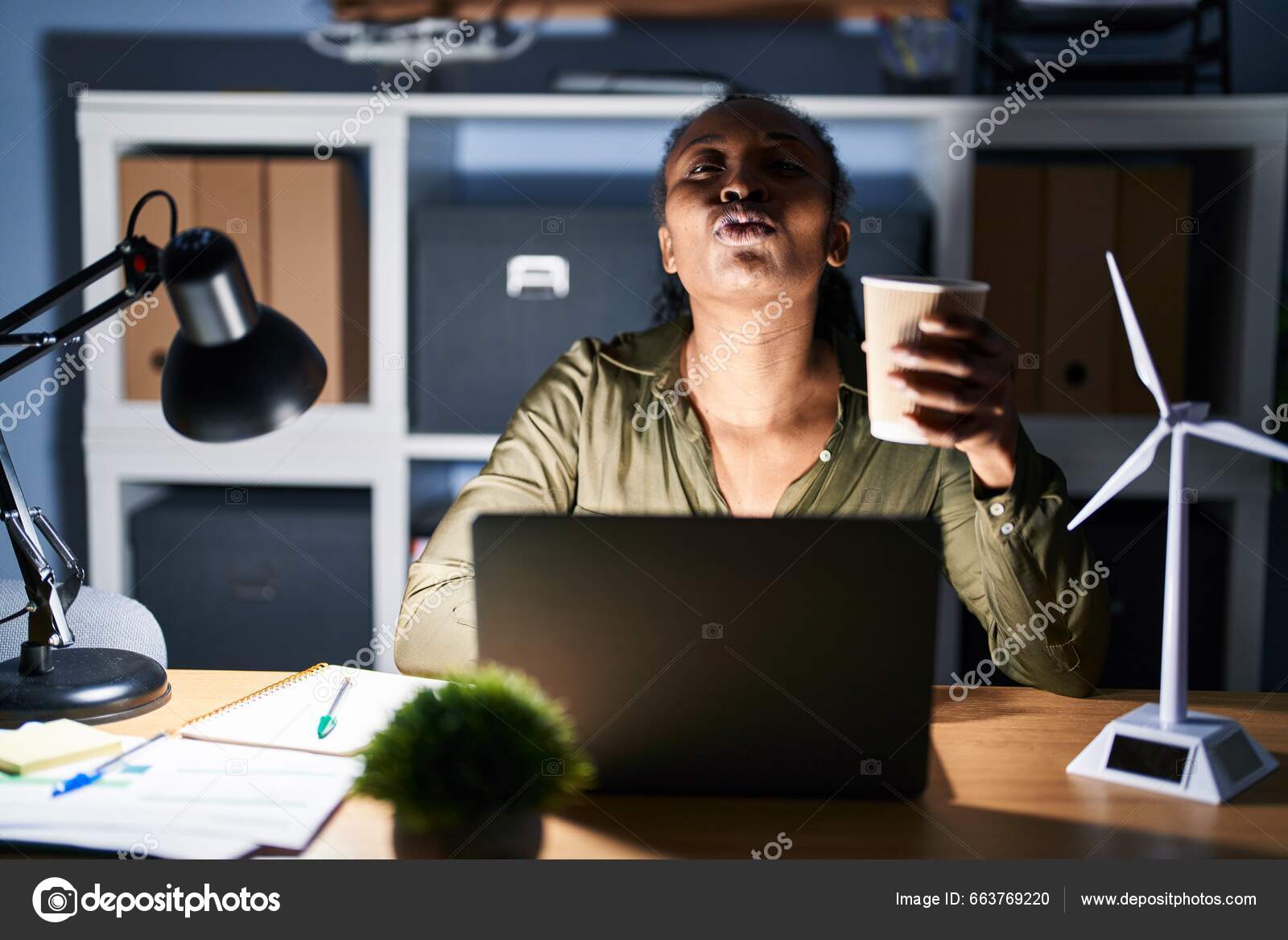 African Woman Working Using Computer Laptop Night Looking Camera Blowing —  Stock Photo © Krakenimages.com #663769220