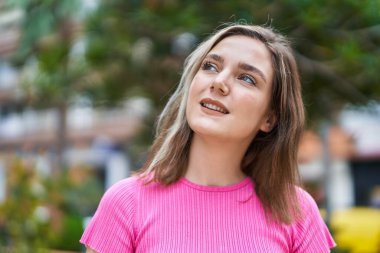 Young woman smiling confident looking to the sky at park