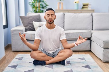 African american man training yoga at home