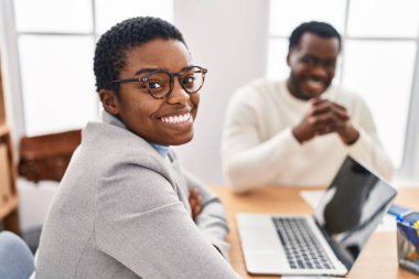 Man and woman business workers using laptop working at office