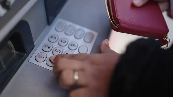 年轻的非洲裔美国妇女在街上的银行取款机上按下密码 — 图库照片