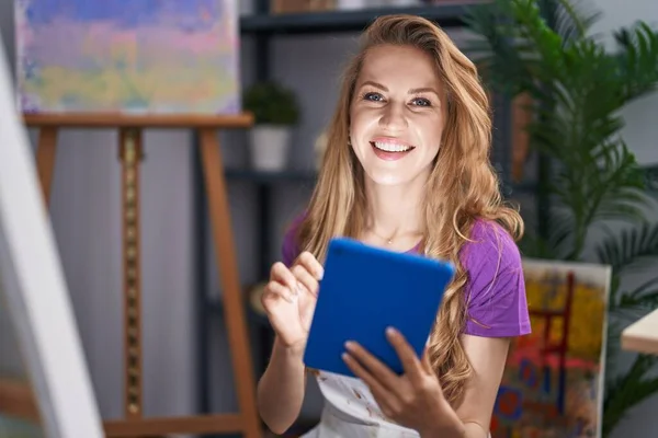 Young Blonde Woman Artist Smiling Confident Using Touchpad Art Studio — стоковое фото