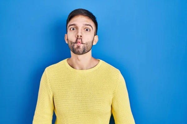 Hispanic Man Standing Blue Background Making Fish Face Lips Crazy — Stok fotoğraf