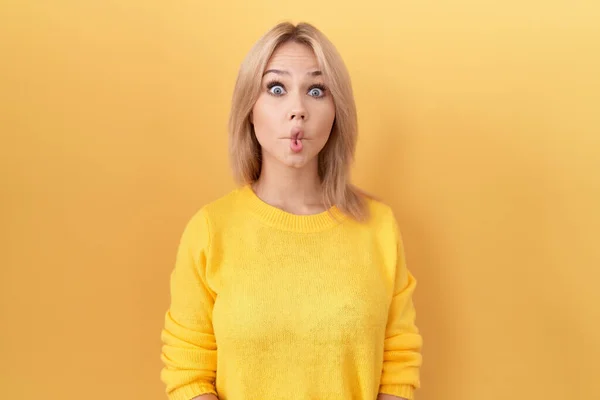 Young Caucasian Woman Wearing Yellow Sweater Making Fish Face Lips — Stock Photo, Image