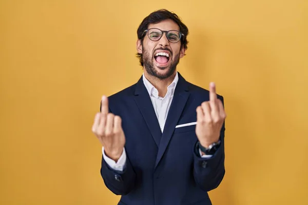 Handsome Latin Man Standing Yellow Background Showing Middle Finger Doing – stockfoto