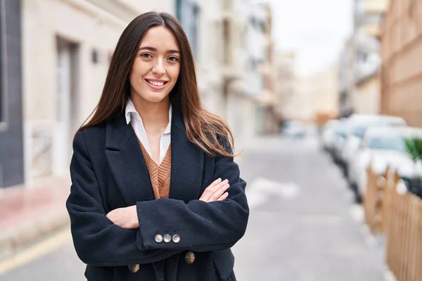 stock image Young beautiful hispanic woman standing with arms crossed gesture at street