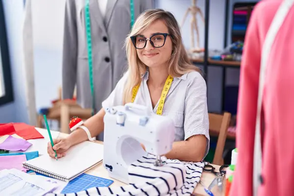 Young Blonde Woman Tailor Smiling Confident Drawing Notebook Tailor Shop — Stock Photo, Image