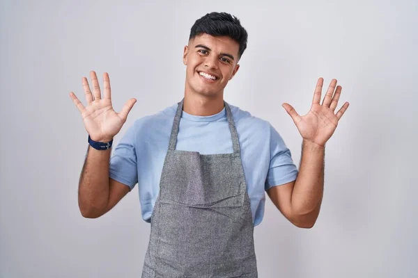 Hispanic Young Man Wearing Apron White Background Showing Pointing Fingers — Stock Photo, Image
