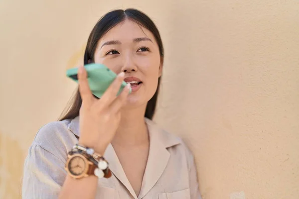 Chinese Woman Smiling Confident Talking Smartphone White Isolated Background — Stock Photo, Image