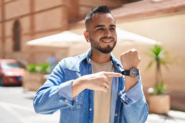 Young Hispanic Man Smiling Confident Pointing Finger Watch Street — Stockfoto
