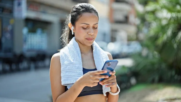 年轻美丽的惊慌失措的女人穿着运动服 在公园里用智能手机 — 图库照片