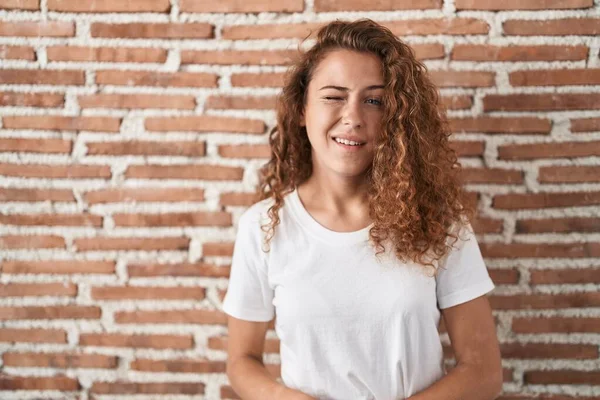Young Caucasian Woman Standing Bricks Wall Background Winking Looking Camera — Stock Photo, Image
