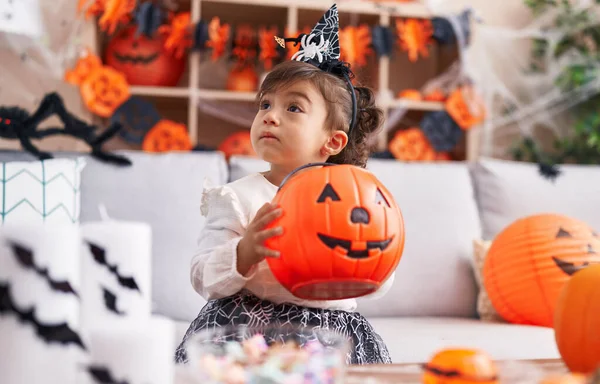 Adorable Hispanic Girl Wearing Halloween Costume Holding Pumpkin Basket Home —  Fotos de Stock