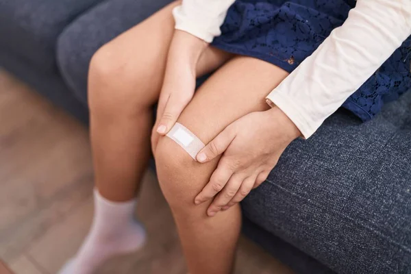Adorable Caucasian Girl Putting Band Aid Knee Home — Stock Photo, Image