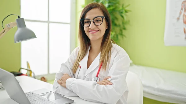 Middle eastern woman doctor using laptop working at clinic