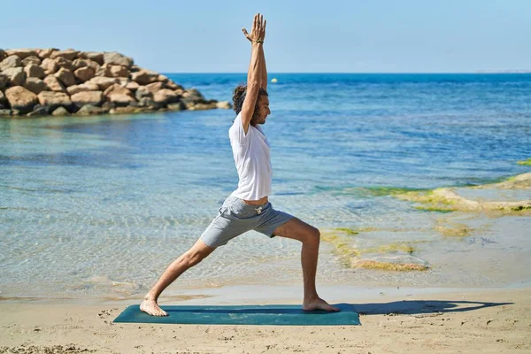 Young Hispanic Man Doing Yoga Exercise Standing Beach — Stock Fotó
