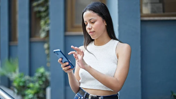 Mujer Hispana Hermosa Joven Usando Teléfono Inteligente Con Expresión Seria — Foto de Stock
